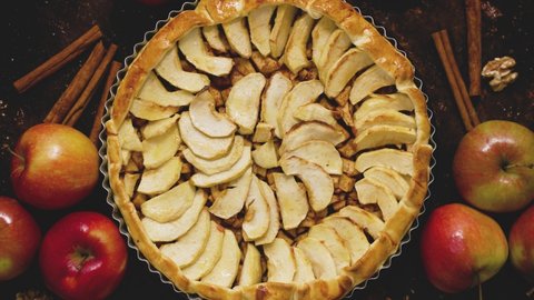 Homemade apple pie on dark rustic background, top view. Classic autumn dessert Stock Video