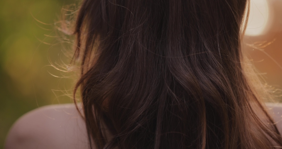Woman touching her beautiful brunette hair at the summer day, back view Royalty-Free Stock Footage #1094190649