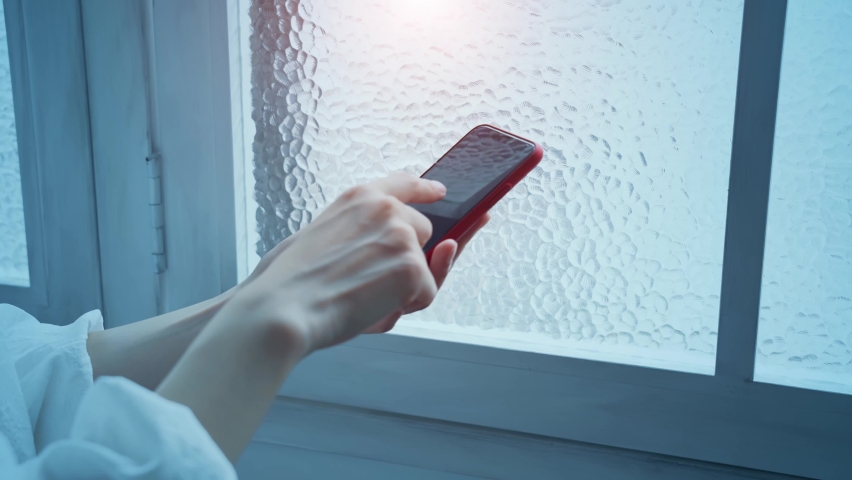 A woman watching a video on her smartphone. Internet video.