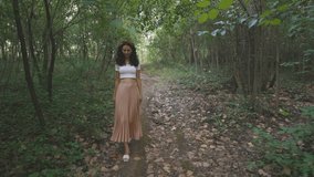Elegant Young Lady Woman Walking Alone in Nature Park Forest Trail, Dolly Tracking Outside Shot of Slim Attractive Girl Walks Touching Tree Branch, Casual Trendy Fashion Brunette Model