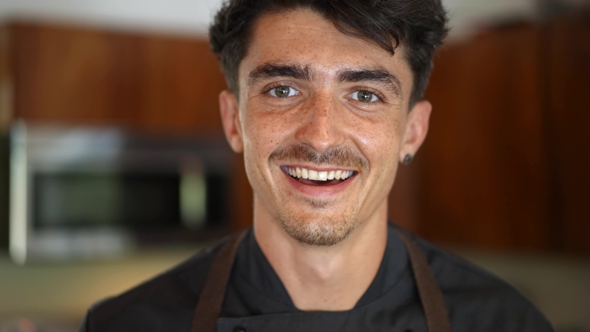 portrait of happy caucasian young chef in the kitchen, happy healthy lifestyle. Concept of craftsmanship, small business, skilled professional millennial. 