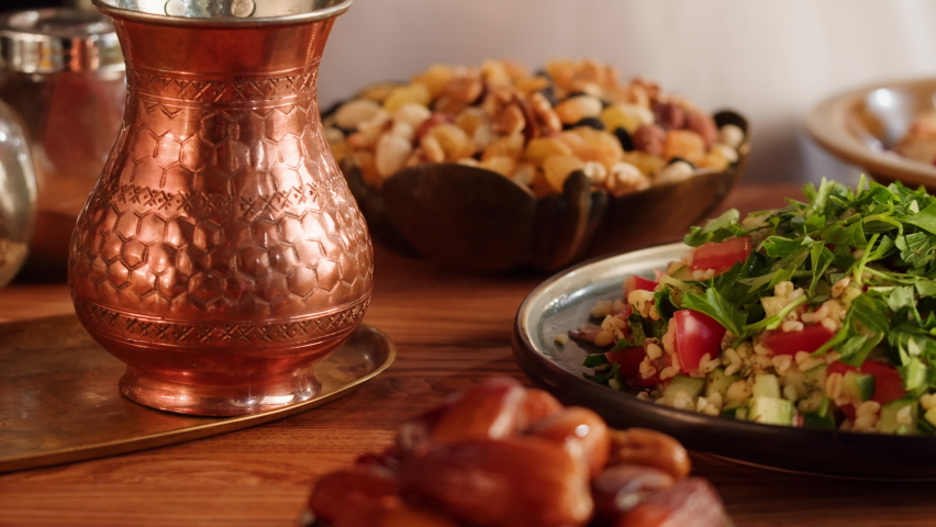 Tabbouleh Vegetable Salad close-up, middle eastern national traditional food. Muslim family dinner, Ramadan, iftar. Arabian cuisine, hummus and dolma dish on table. Royalty-Free Stock Footage #1094199317