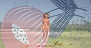 Animation of biracial woman at beach over flower shape. Holidays, free time and digital interface concept digitally generated video.