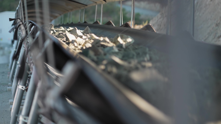 Close up of mine ore rocks being moved on a conveyor belt, slow motion Royalty-Free Stock Footage #1094202707