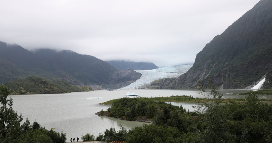 Mendenhall Glacier Alaska nature tourism. Cruise ship destination near Juneau Alaska. Climate change global warming result is rapidly retreating, shrinking, and melting. Large lake formed. Royalty-Free Stock Footage #1094205881