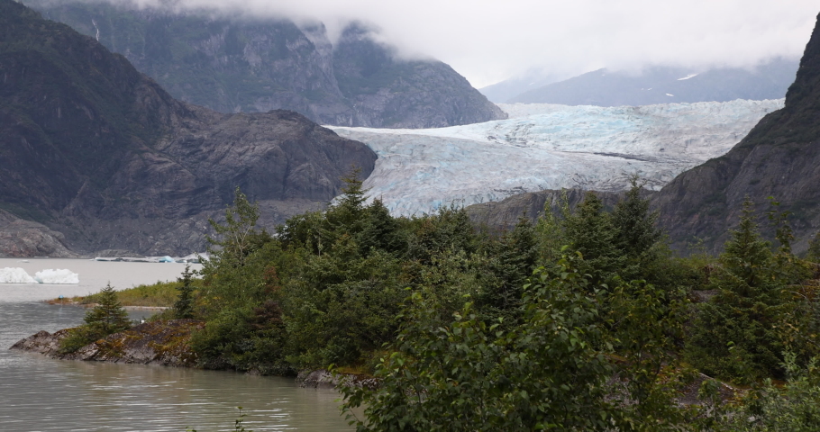 Mendenhall Glacier Juneau Alaska. Cruise ship destination near Juneau Alaska. Climate change global warming result is rapidly retreating, shrinking, and melting. Large lake formed. Royalty-Free Stock Footage #1094205895
