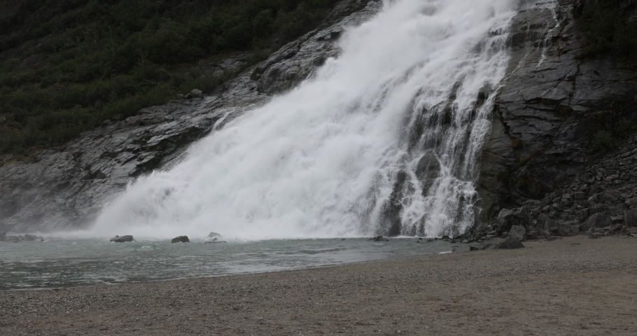 JUNEAU, ALASKA - 28 AUG 2022: Nugget Falls cascade Mendenhall Glacier Alaska close. Waterfall glacier. Cruise ship destination Juneau Alaska. Climate change global warming result is rapidly melting. Royalty-Free Stock Footage #1094205907
