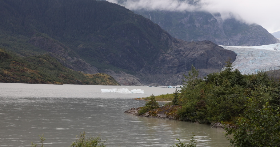 Mendenhall Glacier Juneau Alaska pan. Cruise ship destination near Juneau Alaska. Climate change global warming result is rapidly retreating, shrinking, and melting. Large lake formed. Royalty-Free Stock Footage #1094205917