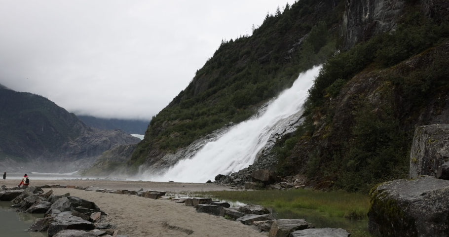 JUNEAU, ALASKA - 28 AUG 2022: Nugget Falls cascade Mendenhall Glacier Alaska. Waterfall from glacier. Cruise ship destination Juneau Alaska. Climate change global warming result is rapidly melting Royalty-Free Stock Footage #1094205941