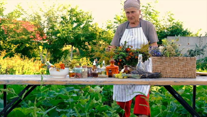 Tinctures and extracts of herbs in a jar woman. Selective focus. Nature.