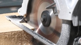 circular saw cutting the wooden plank close up slow motion video
