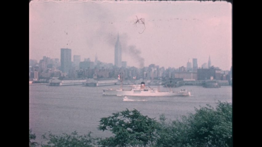 1970s: A boat in city harbor. The Capitol building. Exterior of the New York Stock Exchange. Men stand around the Stock Exchange. Brooklyn Bridge. Historic buildings. Painting of Founding Fathers.