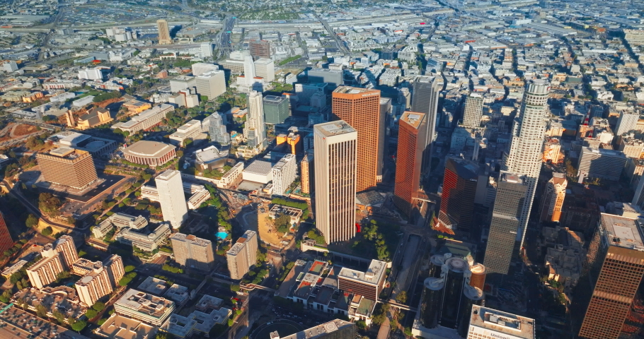Los Angeles, USA - August 2022: Sunlit skyscrapers dropping shadows on the city panorama. Amazing Los Angeles diverse architecture from aerial perspective.