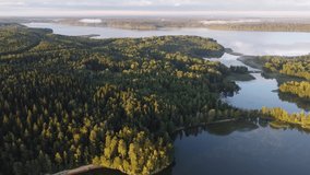 Flying over northern lakes early in the morning at sunrise. Drone video.
