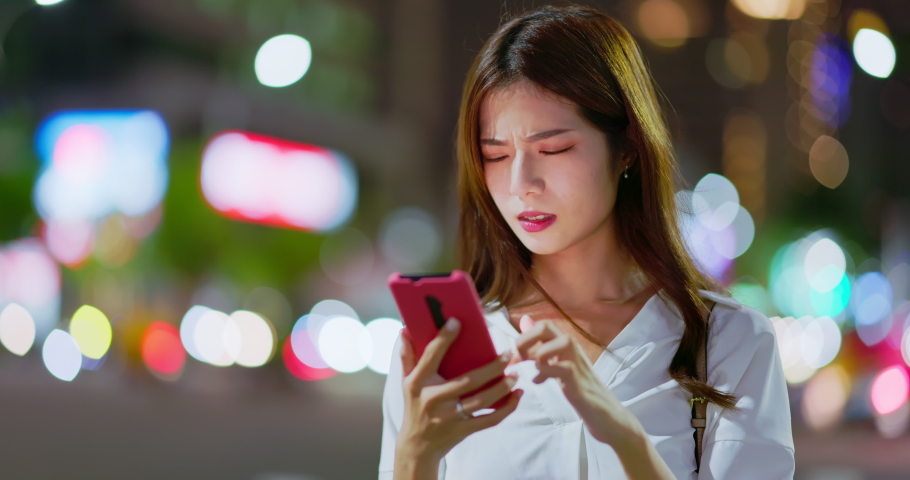 asian businesswoman feel eye tired while using smartphone on the blurred street background in the evening Royalty-Free Stock Footage #1094248531