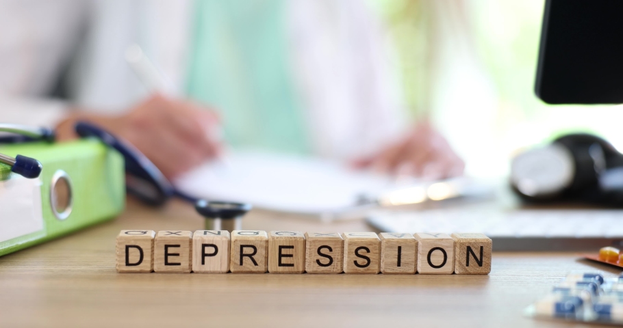 Depression is written with wooden cubes on table at doctor neuropathologist | Shutterstock HD Video #1094251141