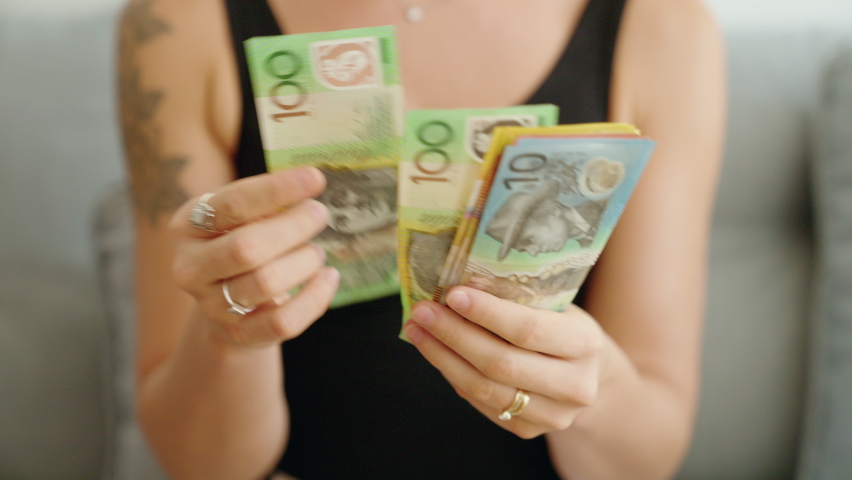 Young woman counting australia dollars banknotes at home Royalty-Free Stock Footage #1094254293