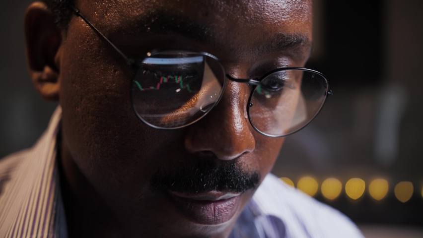 African Man analyzes the cryptocurrency market. Young Financial Analyst Buy Stock on Invest Market Close-up. Person Use Laptop Analyze Growth Stocks Fund. High quality 4k footage