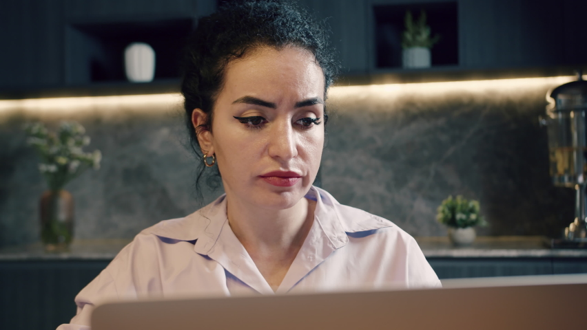 Caucasian serious woman freelancer with worried frustrated face because mistake that happened, working on laptop, sitting in office, using laptop, working on laptop. Concept of online work at home. Royalty-Free Stock Footage #1094255927