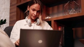 Portrait of attractive woman using laptop in modern library. Young woman sitting in front open laptop computer. Study, learning, remote work, freelance. - Powered by Shutterstock - Get 15% off with code: PIKWIZARD15