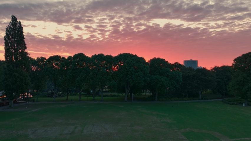 Upwards shot revealing the sunrise and skyline in The Hague, Netherlands, filmed at the zuiderpark (southern park) of the city Royalty-Free Stock Footage #1094258639
