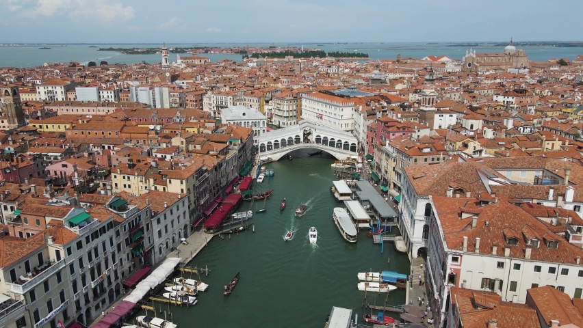 Aerial shot of boats moving under the renowned Ponte di Rialto in venice italy Royalty-Free Stock Footage #1094264775