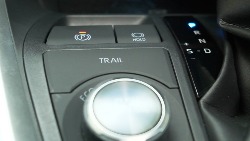 Car interior Closeup. Automatic transmission, gear shift, is moved from P Park to D Drive and back. Car parking and starting a modern car. 