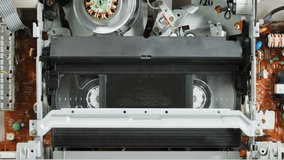 Old video recorder inside close-up, VHS. Retro player, vintage video cassette broadcasting, audio tape. 