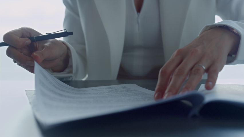 Businesswoman hands checking contract closeup. Lawyer reading legal documents in suit. Unrecognized woman corporate manager analyze financial report agreement. Real estate bank manager meeting client. Royalty-Free Stock Footage #1094268741