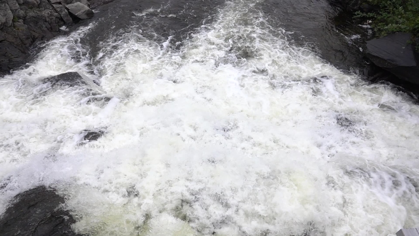 Raging powerfull river and waterfall in slow motion, 2022. Beautiful slow motion shot of water flows inraging river, Sweden
