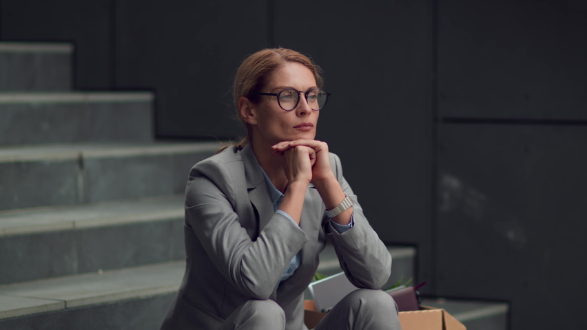 Escape from business problems. Depressed middle aged woman ceo taking off eyeglasses and rubbing her nose bridge, thinking about project, sitting outdoors on stairs, slow motion, free space Royalty-Free Stock Footage #1094274123