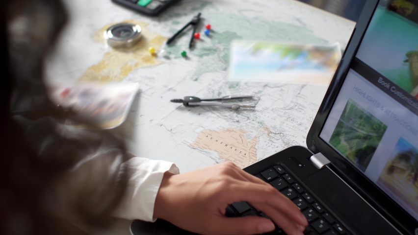 Travel itinerary planning. Young woman with laptop, map indoors at home, planning a trip. Travel planning, destination selection. Map, route, trip. Route guide. Pins located on cities on the world map Royalty-Free Stock Footage #1094274843