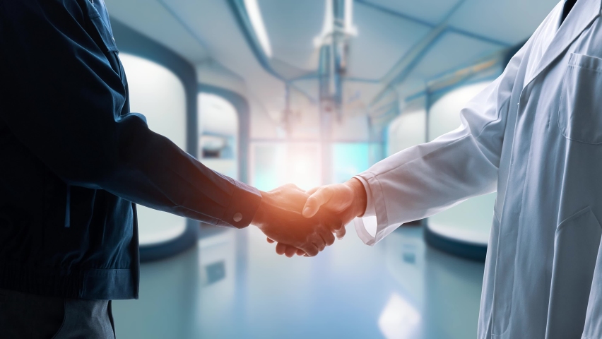 Engineers shaking hands in a laboratory Royalty-Free Stock Footage #1094278609