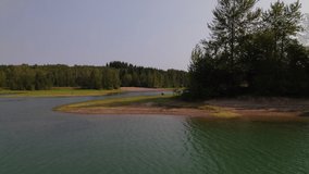 FPV style drone video flying over Alder lake on a hazy late summer morning.