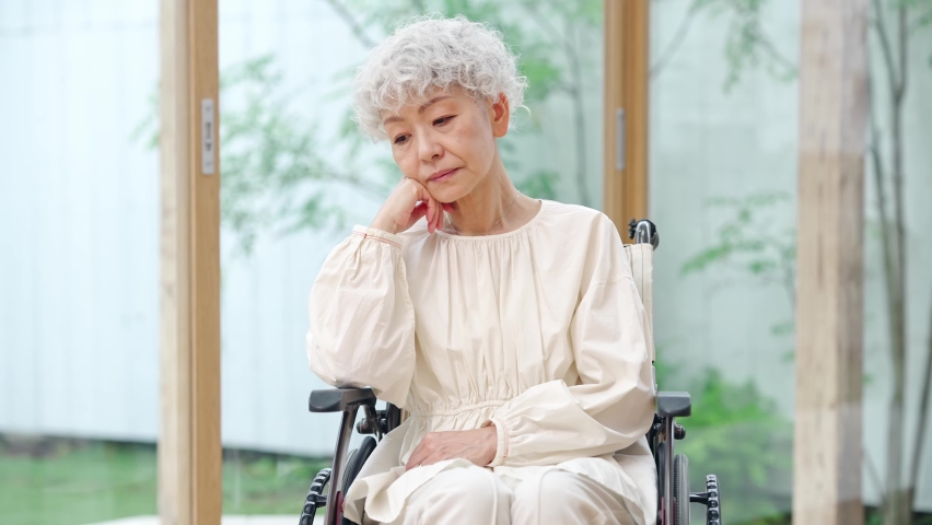 Depressed elderly Asian woman sitting on wheelchair. Royalty-Free Stock Footage #1094278955