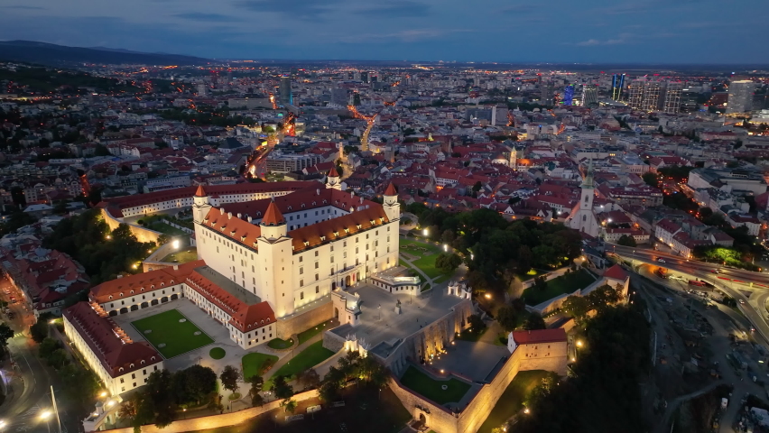 Drone flying at illuminated Bratislava Castle or Bratislavsky Hrad aerial panoramic view after sunset. Slovakia. 4K