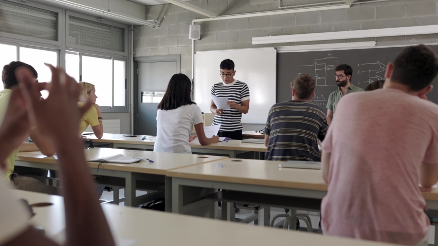 High school hispanic latin student explaining project to multinational group of classmates in classroom. Peruvian teenage boy doing an individual presentation in class. High quality 4k footage | Shutterstock HD Video #1094284591