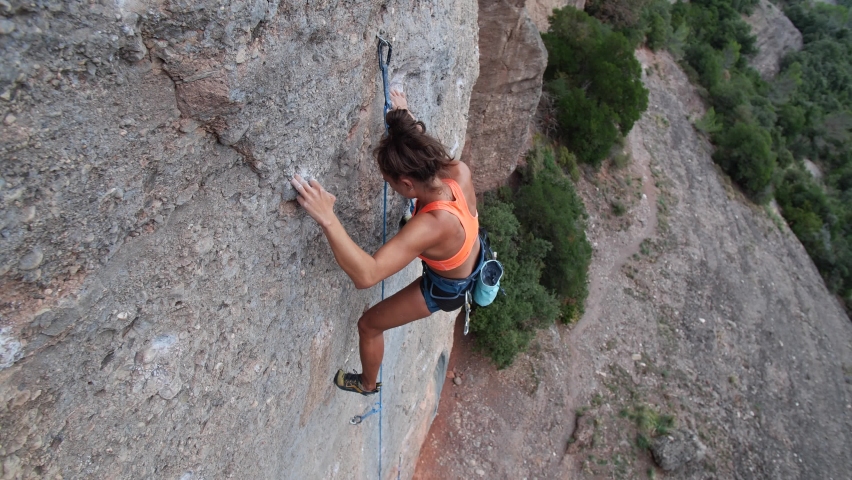 Female climber climbing a hard and steep section of the wall and having a big fall in Sant Llorenç del Mount y l'Obac Natural Park, Catalonia, Spain.
Following camera movement, mid angle, 4K. Royalty-Free Stock Footage #1094285611