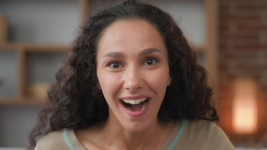 Portrait amazed Hispanic Caucasian business woman lady girl indoors shocked saying WOW looking at camera with open mouth big eyes surprised delight emotions of happiness triumph on female face closeup