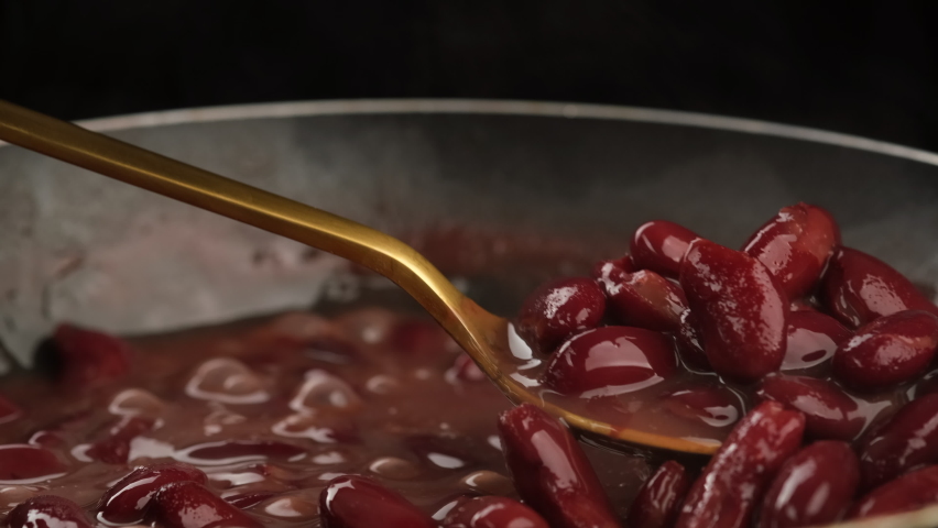 Red kidney beans. Cooking red kidney beans close up. Chef stir beans with spoon