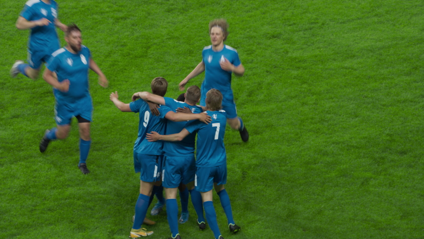 Soccer Football Championship Match: Blue Team Players with Forward Leading and Scoring Perfect Goal, Happy Players Celebrate Victory, Hug Striker. Sport Channel, Television Broadcast, Playback