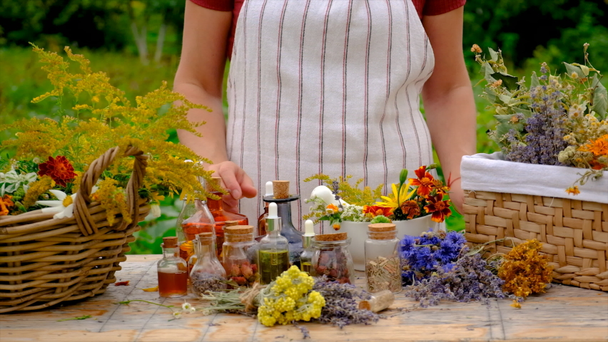 Woman makes tincture with medicinal herbs. Selective focus. Royalty-Free Stock Footage #1094301359