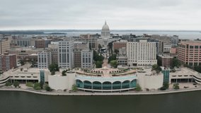 Wisconsin state capitol building and Madison, Wisconsin skyline with drone pulling out.