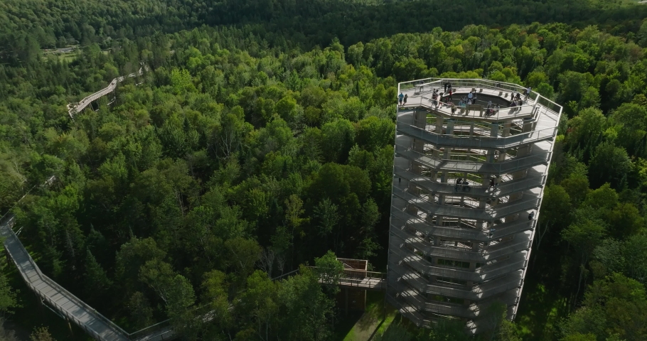 Beautiful wooden tower hiking trail. Mountains and trees. Wide landscape. Marvelous sunny summer day. 4k UHD drone hovering and pulling out. Close point of view. Professional pilot.