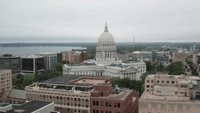 Wisconsin state capitol building in Madison, Wisconsin with medium shot of drone video moving in a circle.