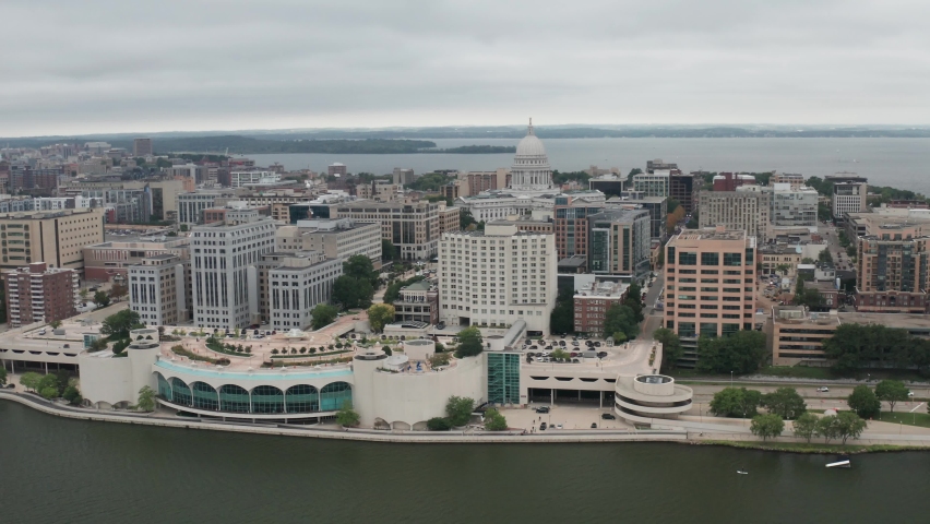 Wisconsin state capitol building with Madison, Wisconsin skyline with drone video wide shot in a circle.