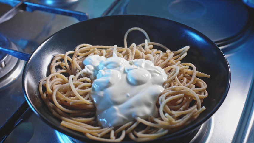 Plating Hot Cooked Spaghetti Pasta With Greek Yogurt Sauce. close up | Shutterstock HD Video #1094312389