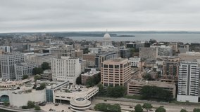 Wisconsin state capitol building and Madison, Wisconsin skyline with drone video at an angle moving in.