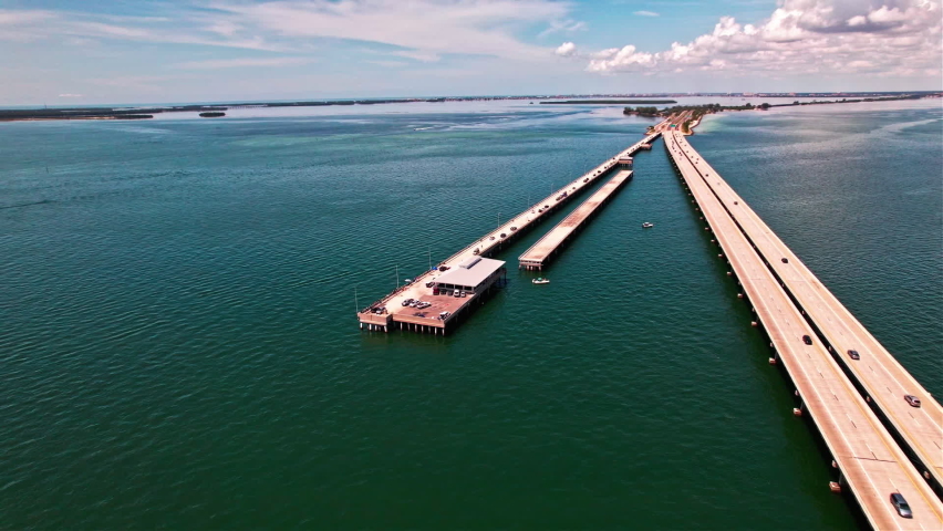 Sunshine Skyway Fishing Pier Next To Bob Graham Sunshine Skyway Bridge On Tampa Bay In Florida. aerial