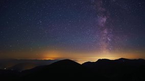 The stars of the Milky Way galaxy move above the mountain hills. From night to day. 4K - Powered by Shutterstock - Get 15% off with code: PIKWIZARD15